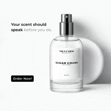 a bottle of truly mine sugar crush perfume sits next to a white circle