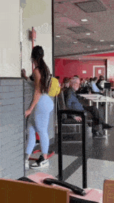 a woman is standing in front of a mcdonald 's sign