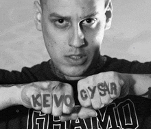 a man with a tattoo on his fist that says kevo gysr