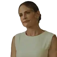 a woman wearing a white dress and earrings is making a sad face
