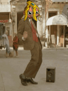 a man in a suit and tie is dancing in front of a shop that says hop