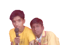 a boy in a yellow shirt that says awesome holds a microphone next to another boy