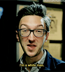 a man wearing glasses and a blue jacket says i 'm a white man
