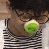 a person wearing glasses and a fake nose with the number 3 on it