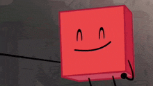 a red cube with a smiling face is standing next to a microphone