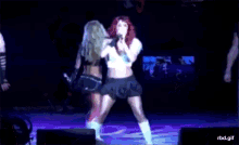 a woman with red hair singing into a microphone