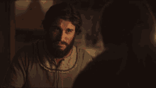 a man with a beard is talking to another person