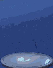 a silhouette of a person standing in front of a blue pillar