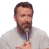 a man with a beard holds a microphone in his hand