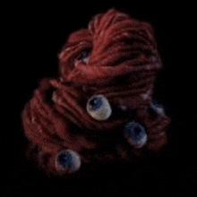a close up of a squid with three eyes on it .