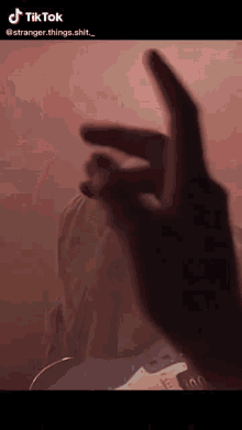 a person 's hand is visible in a tik tok video