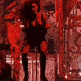 a woman is standing in front of a microphone on stage
