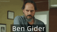a man with a beard has the name ben gider on the bottom