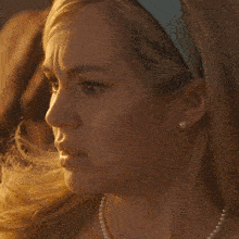 a close up of a woman 's face with a blue headband