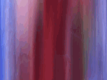 a close up of a red and blue curtain with a blurred background .