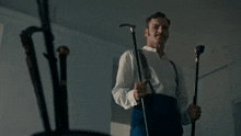 a man holding a cane with the words ehh i like this one behind him