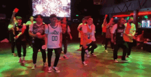 a group of people are dancing and one of them is wearing a jersey that says jazz 00