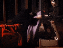 a man is opening a suitcase filled with clothes