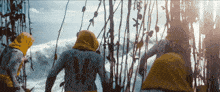 a person with the number 14 on their back stands in front of a body of water