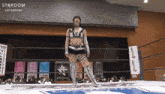 a woman in a wrestling ring with the word stardom on the top