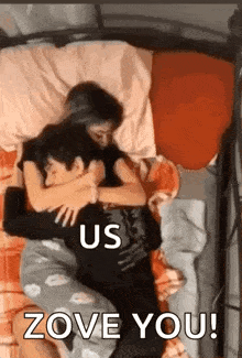 a man and a woman are laying in bed hugging each other .