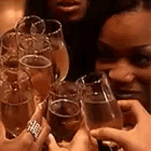 a group of people are holding champagne glasses in their hands and toasting .