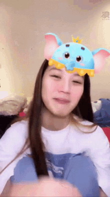 a woman wearing a blue dumbo mask on her face