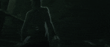 a shadow of a person is cast on a green floor