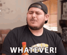 a man with a beard is wearing a black shirt that says whatever on it