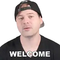 a man wearing a black hat and a black shirt with the word welcome on it