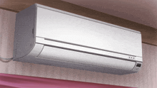 a white air conditioner is hanging from the ceiling in a bedroom