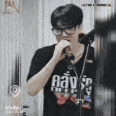 a man singing into a microphone with a shirt that says deep