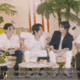 a group of people are sitting around a table and talking .