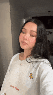 a woman taking a selfie with her eyes closed
