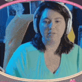 a woman wearing headphones is looking at the camera