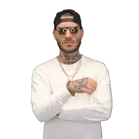 a man wearing sunglasses and a hat is giving a thumbs down