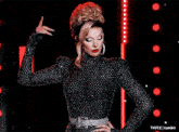 a woman in a black and white polka dot dress stands in front of red lights and says t4yce tumblr