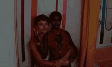 a man and a woman pose for a picture in a room