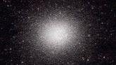 a cluster of stars in the night sky with a large white star in the middle
