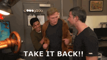 three men are standing in a room with the words take it back written on the bottom right