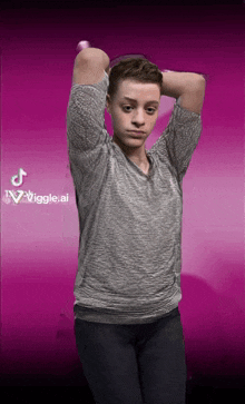 a boy in a grey shirt stands in front of a pink background that says wiggle ai
