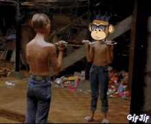 a boy lifting dumbbells in front of a mirror with a cartoon monkey on his head