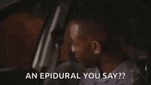 a man is sitting in the driver 's seat of a car and asking , `` an epidural you say ? ''