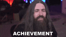 a man with long hair and a beard has the word achievement written on his face