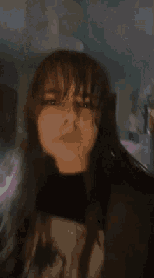 a girl with long hair is wearing a black shirt that says ' s ' on it