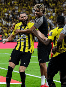 a soccer player wearing a jersey that says roshn sud