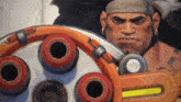a man with a bandana on his head is standing next to a machine that has a yellow bar on it