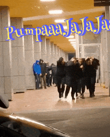 a group of people walking in front of a building that says pumpaaajajaja
