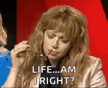 a woman is holding a pair of scissors in her hand and says `` life ... am i right ? ''