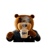 a teddy bear in a suit is drinking from a gm mug